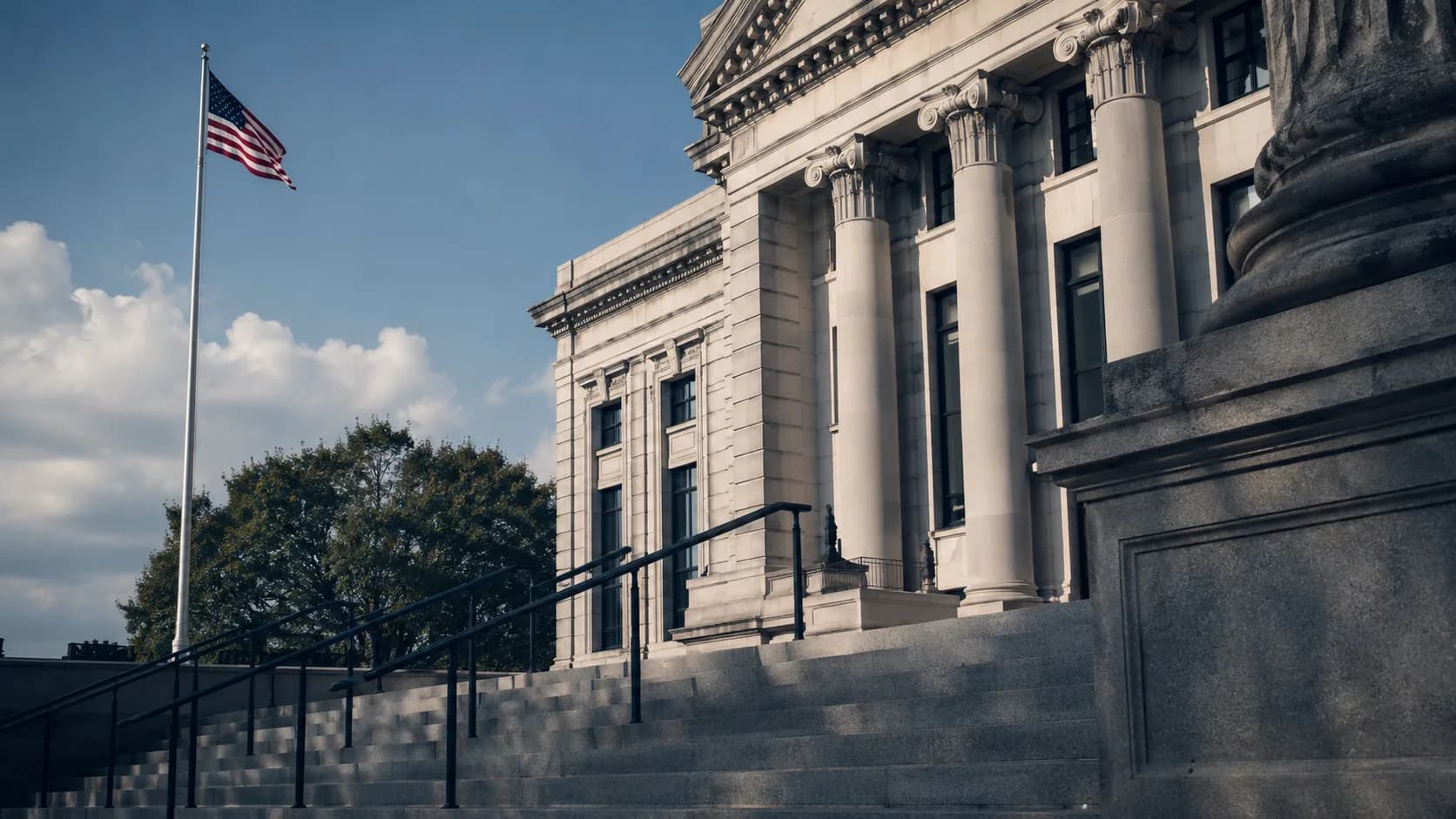 Exterior of a Hampton Roads Virginia courthouse with stone steps and an American flag